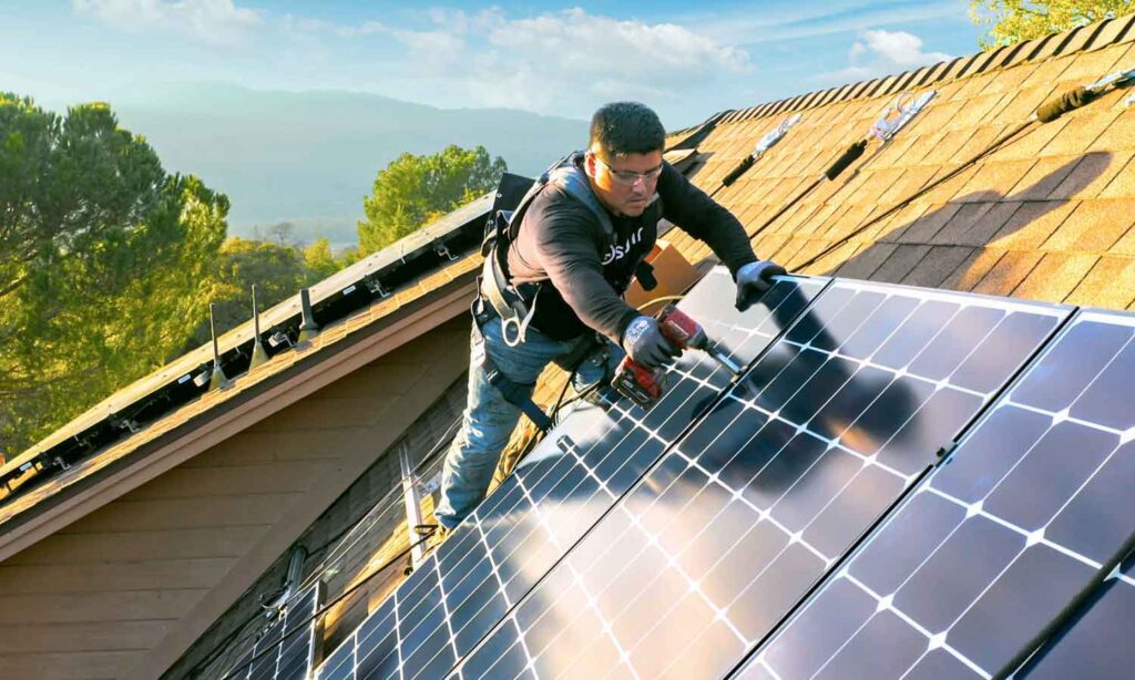 Solar installers installing solar panels on a home