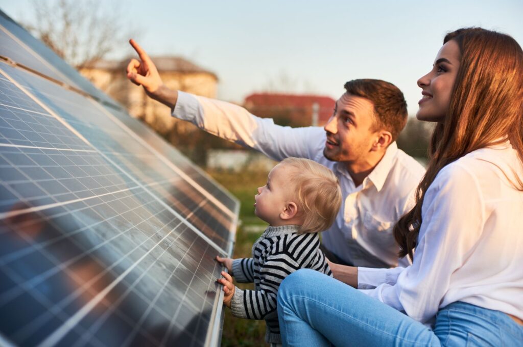 Family looking at solar panel